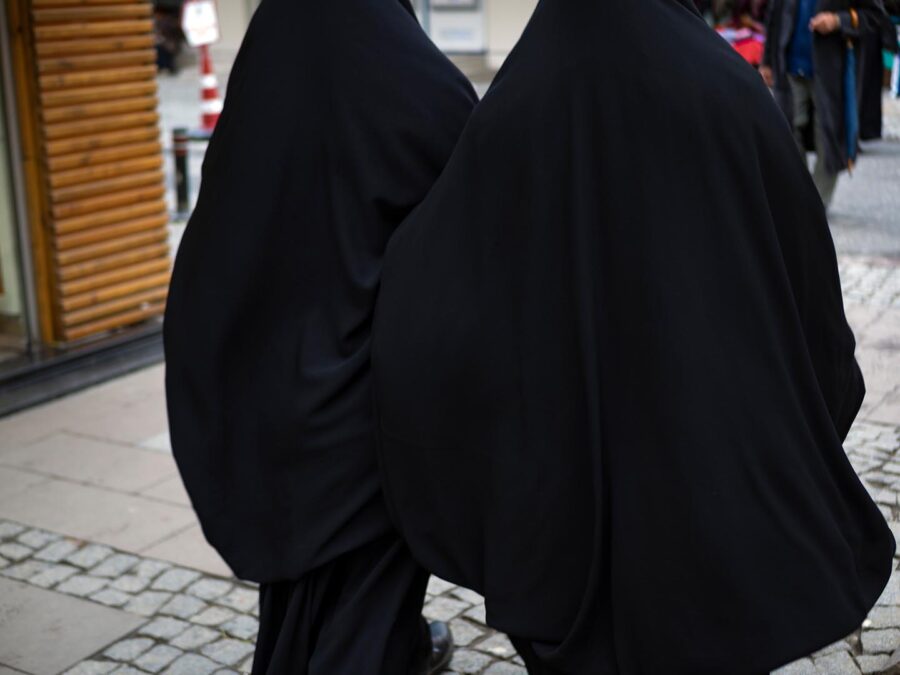 Two Islamic women in long black dresses