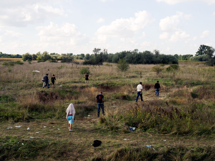 People walking in the vast grasslands